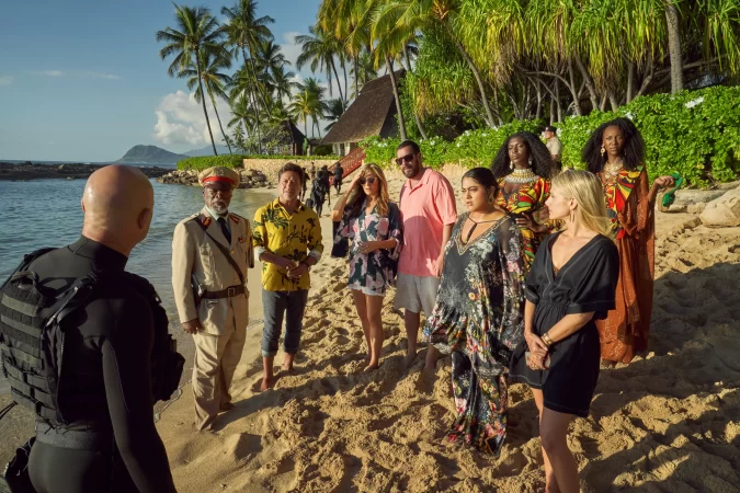 (L-R) Mark Strong as Miller, John Kani as Colonel Ulenga, Enrique Arce as Francisco, Jennifer Aniston as Audrey Spitz, Adam Sandler as Nick Spitz, Kuhoo Verma as Saira, Jodie Turner-Smith as Countess, Melanie Laurent as Claudette Joubert and Zurin Villanueva as Imani in Murder Mystery 2. Cr. Scott Yamano/Netflix © 2023.