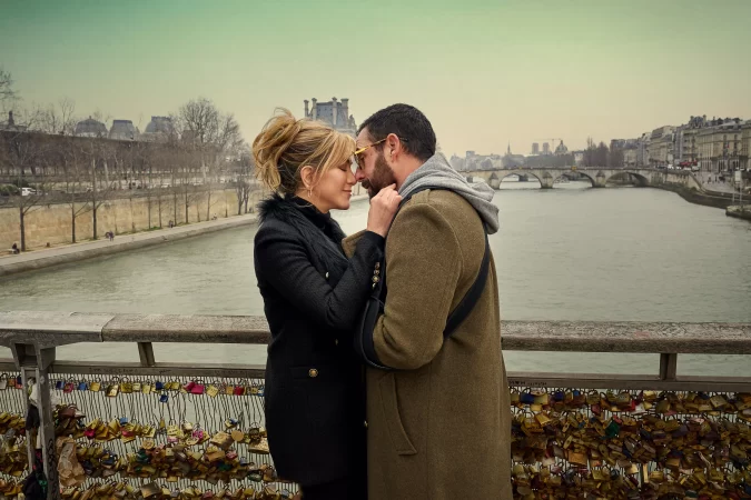 L-R) Jennifer Aniston as Audrey Spitz and Adam Sandler as Nick Spitz in Murder Mystery 2. Cr. Scott Yamano/Netflix © 2023.